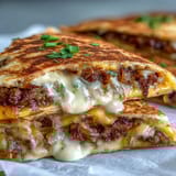 Piping-hot Cheesy Griddled Smashburger Quesadillas served on a plate with a side of tangy mayo-mustard dipping sauce.
