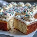 Fluffy vanilla sheet cake with creamy buttercream, decorated with graduation-themed sprinkles for a festive celebration dessert.