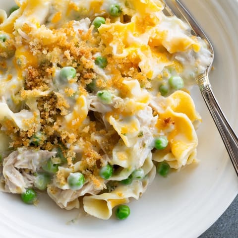 Hot Tuna Casserole with creamy noodles, sweet green peas, and flaky tuna, ready to serve for dinner.