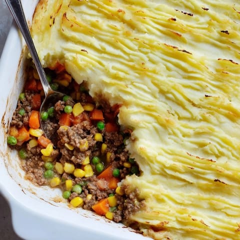 Bubbling, golden-crowned Shepherd's Pie casserole fresh from the oven, ready for a comforting weeknight dinner.