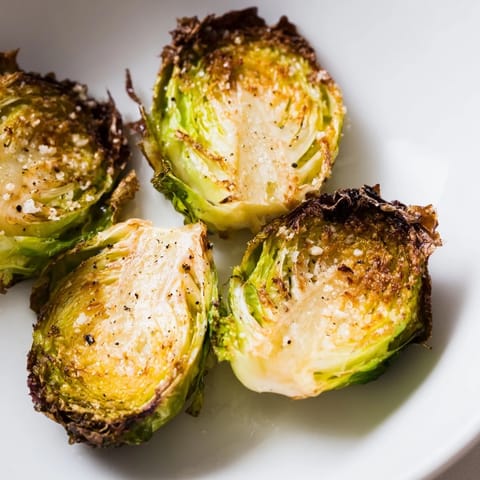 Roasted Brussels sprouts tossed in olive oil and seasonings, served hot as a nutty, sweet side for dinner.