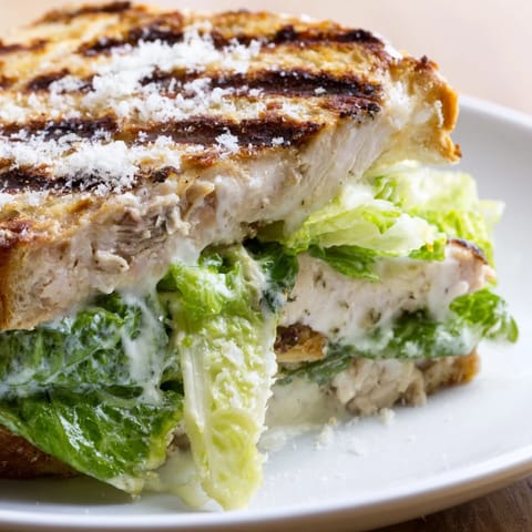Grilled chicken cutlets and crisp romaine lettuce layered with creamy Caesar dressing on a toasted brioche bun.