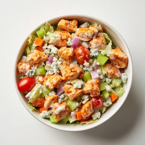 Crisp romaine, tangy buffalo chicken, and crunchy celery tossed with blue cheese and drizzled with cool ranch dressing.  