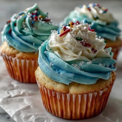 A close-up of Gemini birthday cupcakes showcasing colorful buttercream and fluffy vanilla cake.