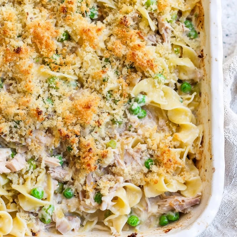 Steamy, savory Tuna Casserole with tender noodles and tuna flakes, ready to serve at a family dinner.