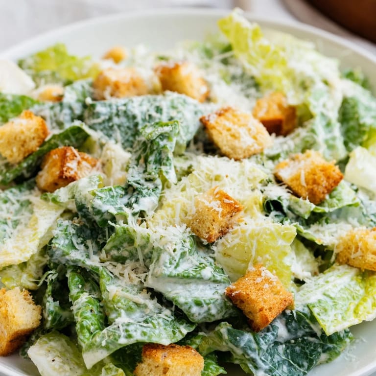 Homemade Caesar salad served as a light lunch, topped with extra grated Parmesan and black pepper.