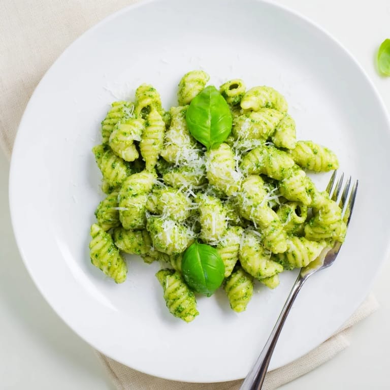 Bright green avocado pesto sauce coats the tender macaroni in this Creamy Avocado Pesto Mac recipe, perfect for dinner.