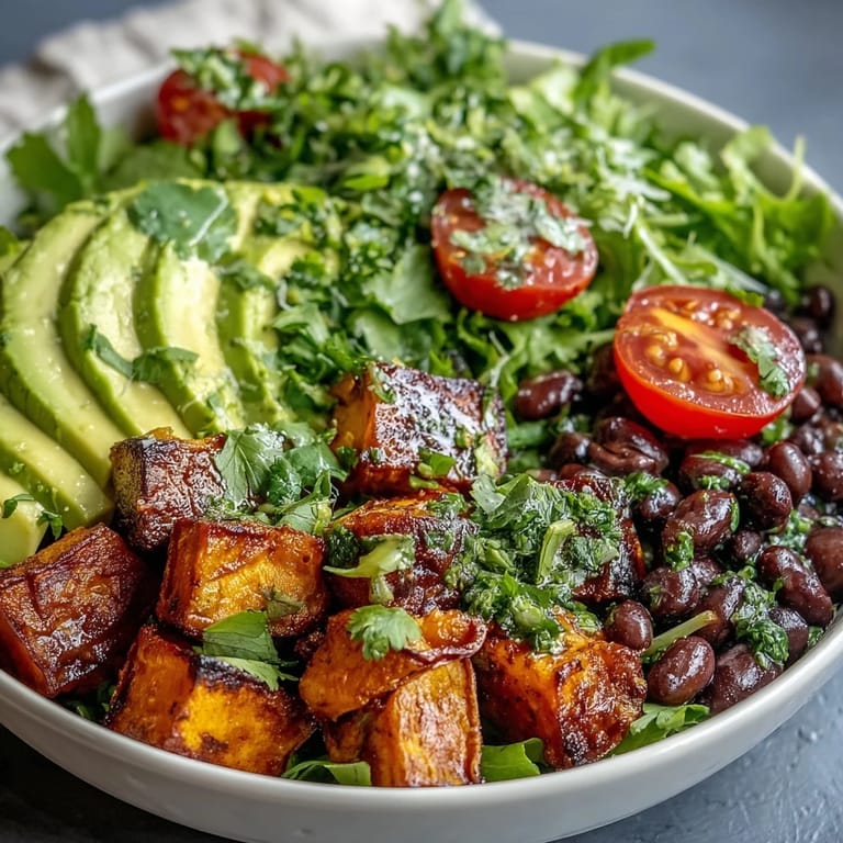 A vibrant Sweet Potato and Black Bean Bowl garnished with cilantro and lime wedges, ready for a healthy dinner.
