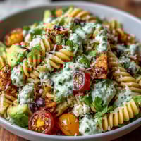 Easy Taco Pasta Salad with colorful vegetables, creamy dressing, and cheddar cheese in a vibrant, summer-ready dish.